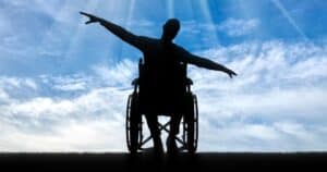 Silhouette of happy disabled man in wheelchair