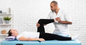male physiotherapy checking woman's leg