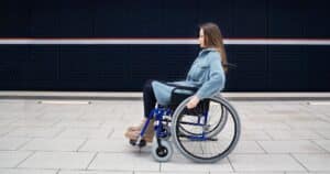 serious woman in a manual wheelchair
