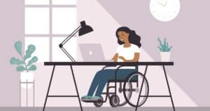 woman in wheelchair working at desk on computer