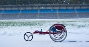 wheelchair for winter paraplegic athletes in a snowy field
