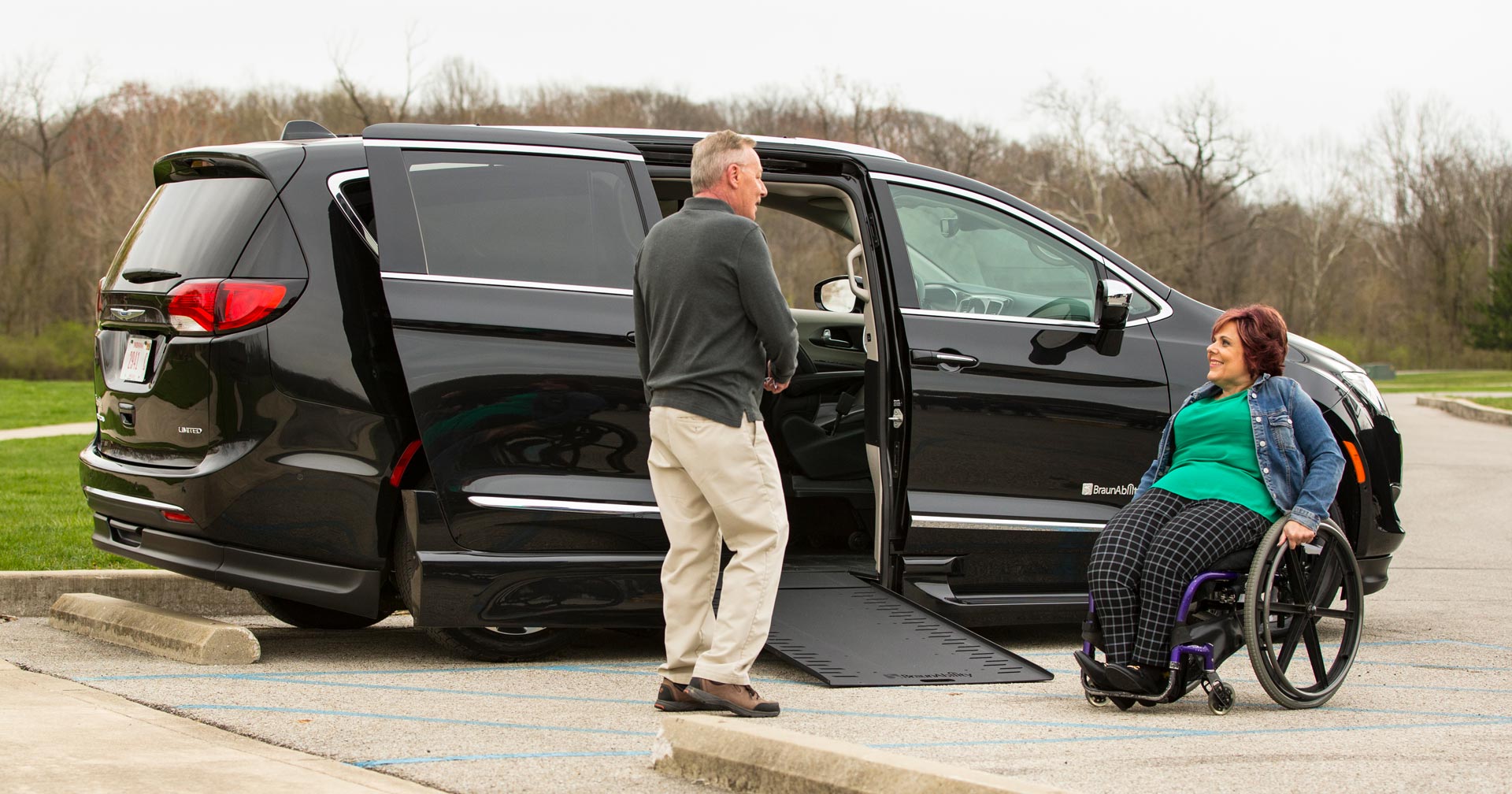 couple near Chrysler Pacifica wheelchair van woman in wheelchair