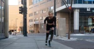 woman with prosthetic legs running in the city