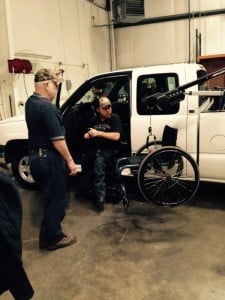 Van Products technician, Jim Waters, showing Justin Allison how to use his handicapped truck