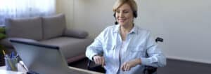 businesswoman in wheelchair working in office, virtual meeting online